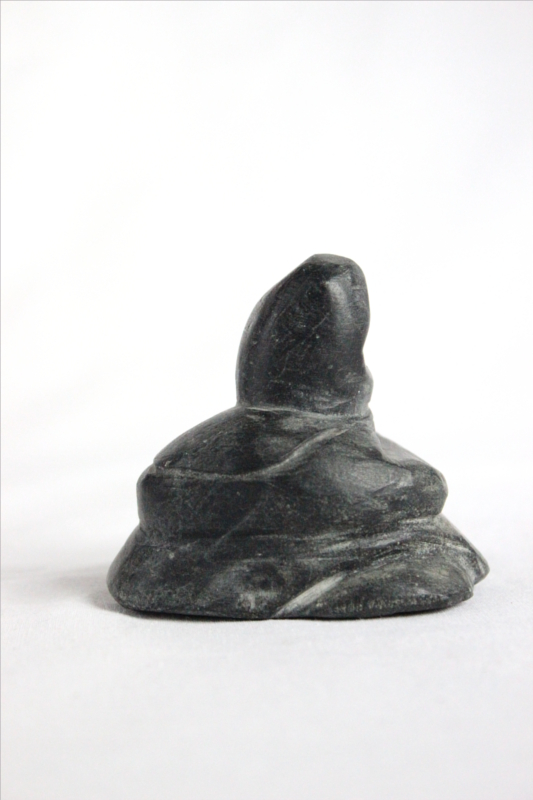 Inuit carving of resting woman by David Toolooktook
