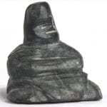 Inuit carving of resting woman by David Toolooktook