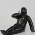 Man smoking pipe carved by Isaaci Etidloie