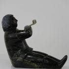 Man smoking pipe carved by Isaaci Etidloie