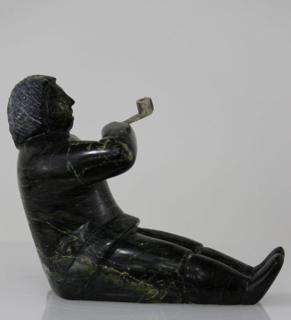 Man smoking pipe carved by Isaaci Etidloie