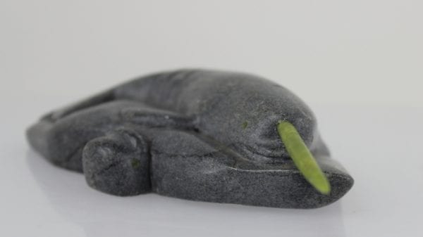 Inuit carving of a narwhale with green tusk