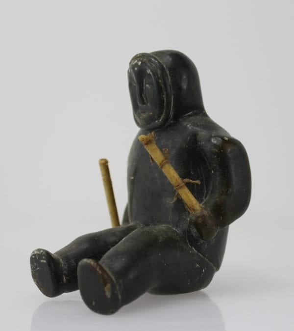 Sitting man with clubs, unknown carver, thought to be from 1960s