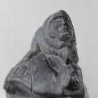 Stone carving of a hunter and seal by Aisa Amittuk, an Inuit artist from Akulivik