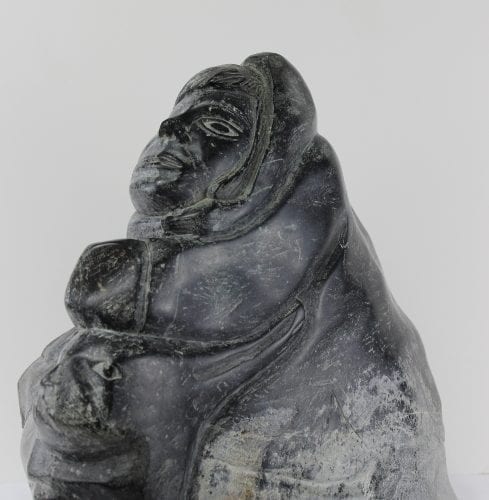 Stone carving of a hunter and seal by Aisa Amittuk, an Inuit artist from Akulivik