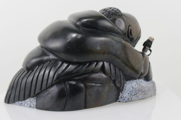 Gorgeous carving of an Inuit woman fishing by Adamie Inukpuk