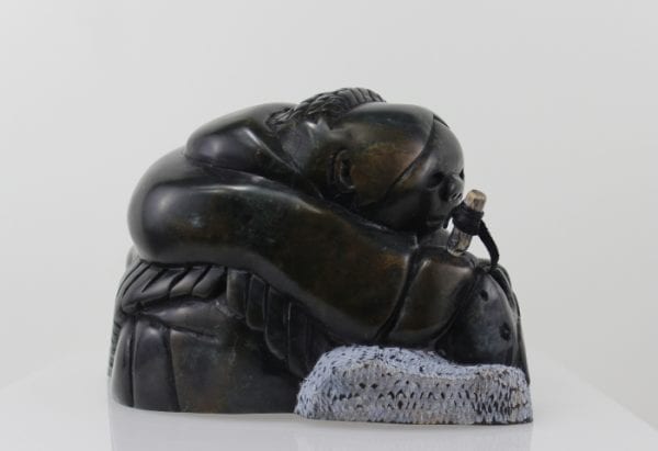 Gorgeous carving of an Inuit woman fishing by Adamie Inukpuk