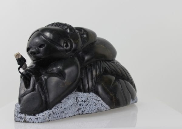 Gorgeous carving of an Inuit woman fishing by Adamie Inukpuk