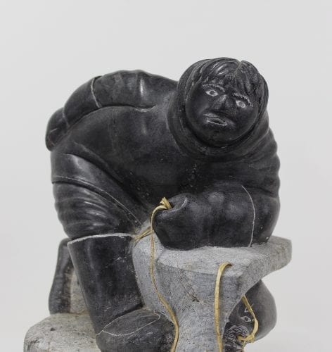 Wonderful carving of a man fishing by an unknown Inuit artist