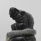 Wonderful carving of a man fishing by an unknown Inuit artist