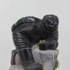 Wonderful carving of a man fishing by an unknown Inuit artist