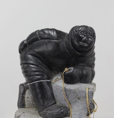 Wonderful carving of a man fishing by an unknown Inuit artist