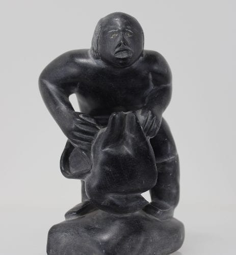 Wonderful carving of a man dressing by an unknown Inuit artist