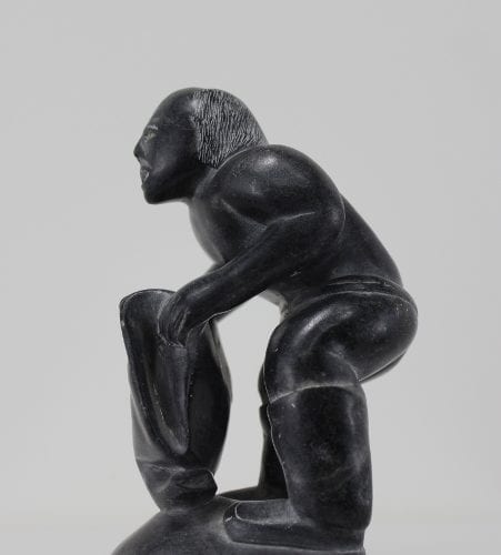 Wonderful carving of a man dressing by an unknown Inuit artist