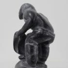 Wonderful carving of a man dressing by an unknown Inuit artist