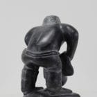 Wonderful carving of a man dressing by an unknown Inuit artist