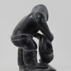 Wonderful carving of a man dressing by an unknown Inuit artist