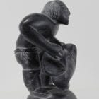 Wonderful carving of a man dressing by an unknown Inuit artist