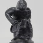 Wonderful carving of a man dressing by an unknown Inuit artist