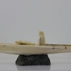 Ivory hunter and kayak carved by an unknown Inuit artist. Thought to be from Pangnirtung.