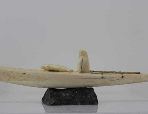 Ivory hunter and kayak carved by an unknown Inuit artist. Thought to be from Pangnirtung.