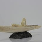 Ivory hunter and kayak carved by an unknown Inuit artist. Thought to be from Pangnirtung.