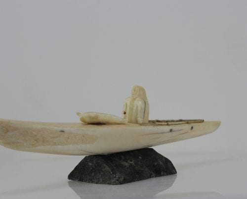 Ivory hunter and kayak carved by an unknown Inuit artist. Thought to be from Pangnirtung.