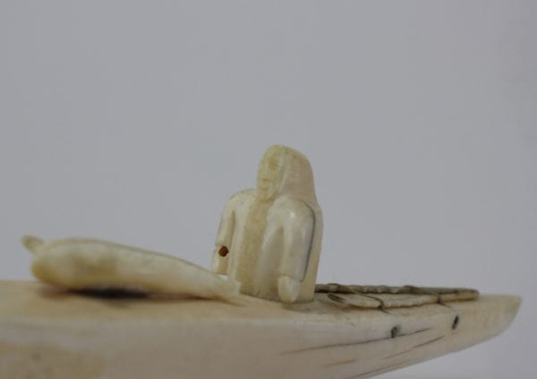 Ivory hunter and kayak carved by an unknown Inuit artist. Thought to be from Pangnirtung.