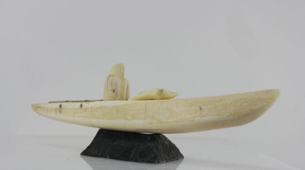 Ivory hunter and kayak carved by an unknown Inuit artist. Thought to be from Pangnirtung.