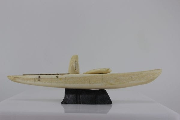 Ivory hunter and kayak carved by an unknown Inuit artist. Thought to be from Pangnirtung.