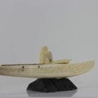 Ivory hunter and kayak carved by an unknown Inuit artist. Thought to be from Pangnirtung.