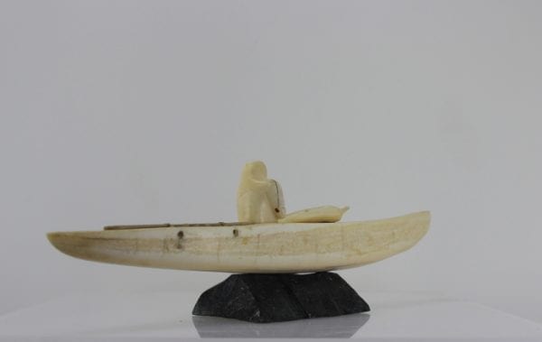 Ivory hunter and kayak carved by an unknown Inuit artist. Thought to be from Pangnirtung.