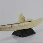 Ivory hunter and kayak carved by an unknown Inuit artist. Thought to be from Pangnirtung.