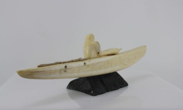 Ivory hunter and kayak carved by an unknown Inuit artist. Thought to be from Pangnirtung.