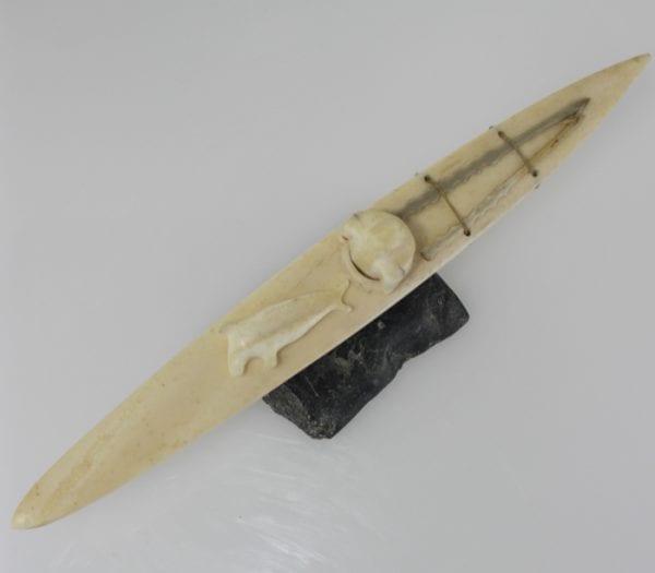 Ivory hunter and kayak carved by an unknown Inuit artist. Thought to be from Pangnirtung.