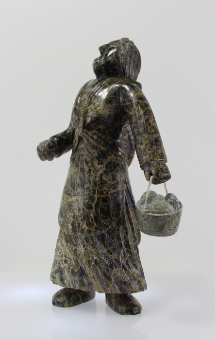 Wonderful carving of a woman with a pail of eggs, carved by Pitseolak Qimirpik