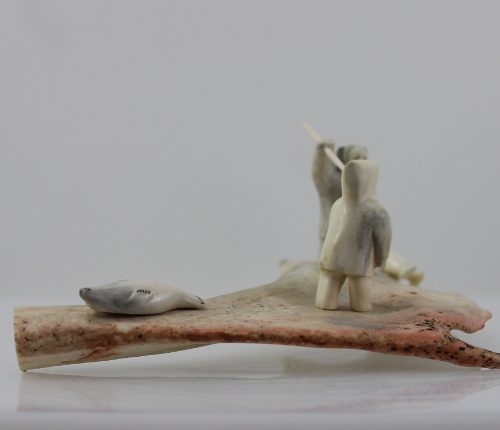 Men and seals is a stunning piece by master carver Emily Illuitok.