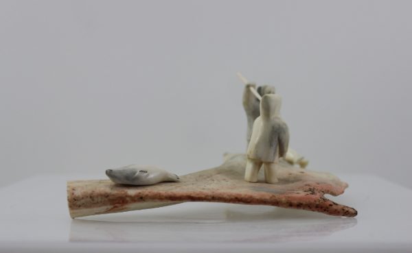 Men and seals is a stunning piece by master carver Emily Illuitok.